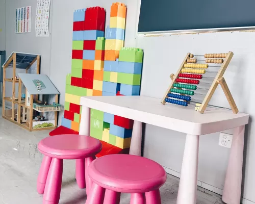 a room with toys chairs and a table