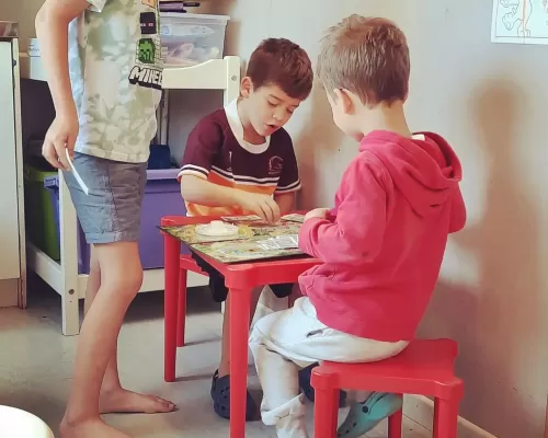 three kids playing a board game